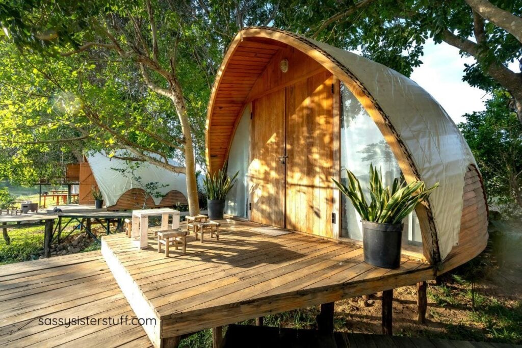 an outdoor wooden tent for glamping in the woods.
