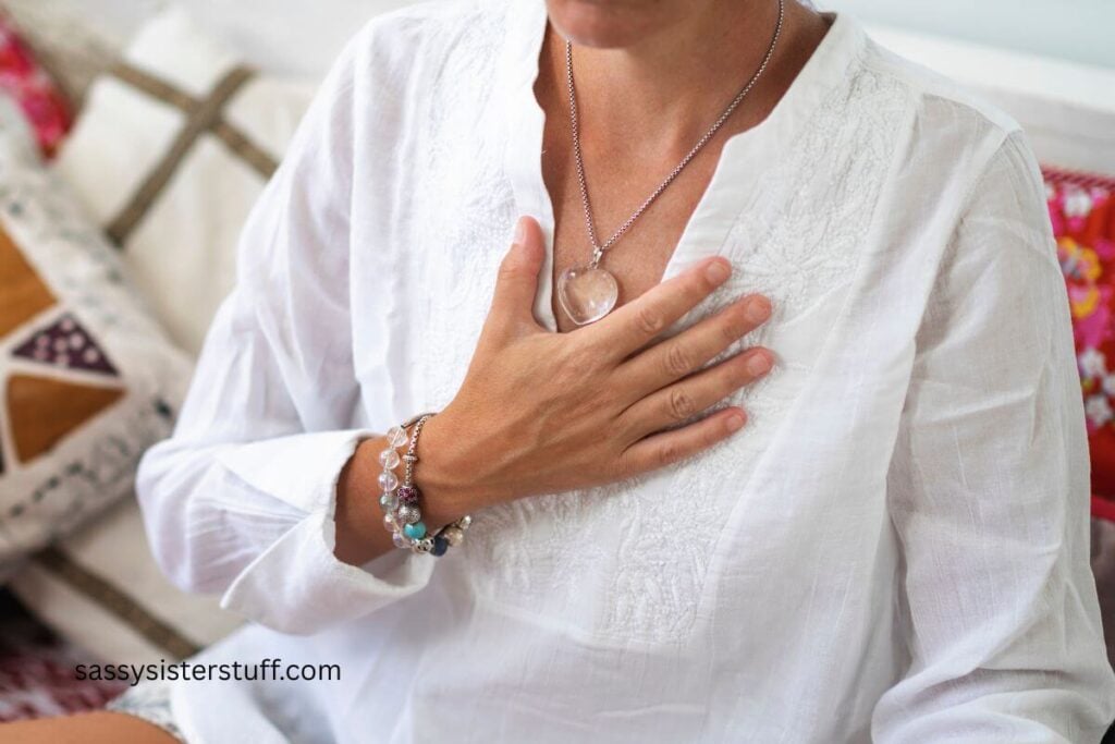 close-up of woman holding her hand to her chest to promote mindfulness and reset.