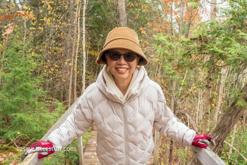 midlife Asian woman taking a walk in the forest as she contemplates life.