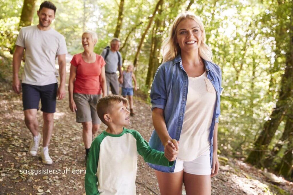 multigenerational family hiking on a trails at a park.