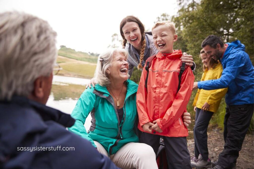 multigenerational family having a cookout on the shore of a lake.