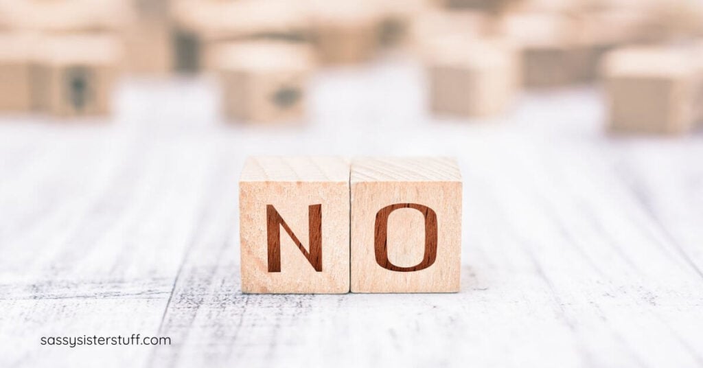 close-up of two simple wooden blocks that say NO.
