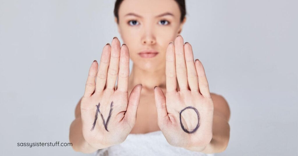 woman holds her palms out with N and O written on them to show she has boundaries and backbone in midlife.