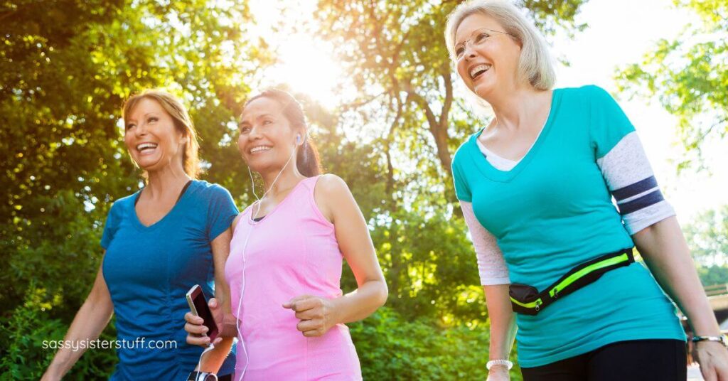 three midlife women walking in the park.