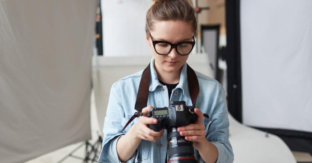 professional protographer in a lab looking at pictures on her camera.