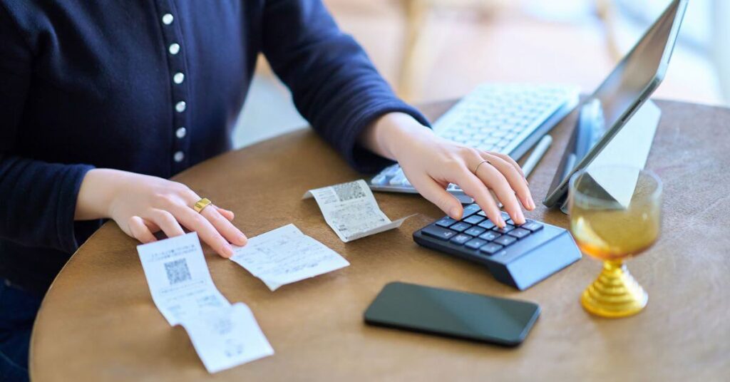 professional female adding up receipts for a lawsuit.