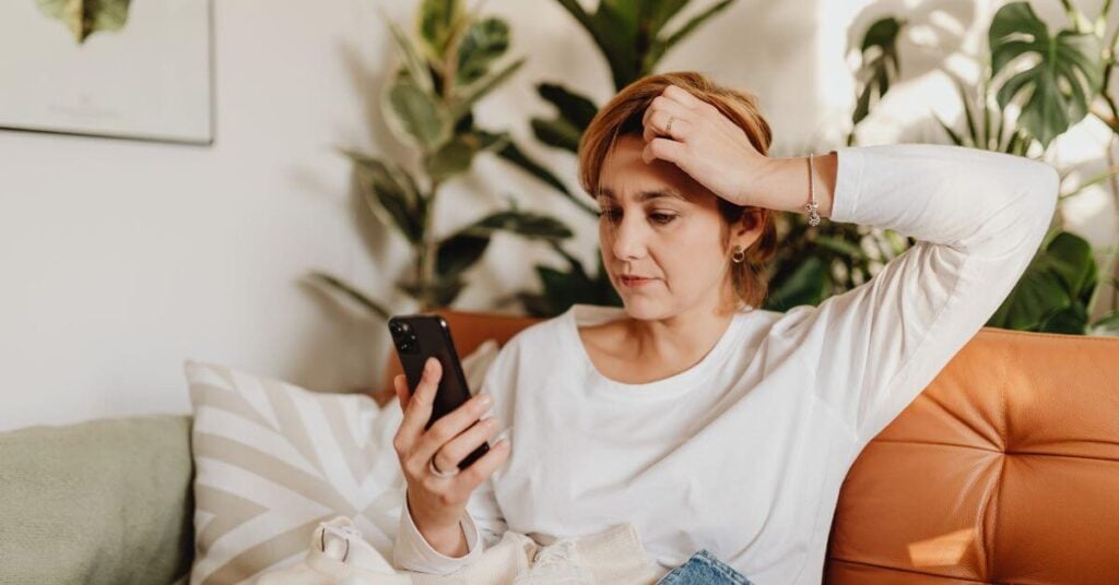 injured woman making a phone call to report injury by a product she purchased.