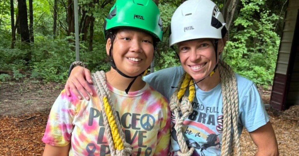 Mother Pam and adopted daughter Kelsey prepare to go ziplining.