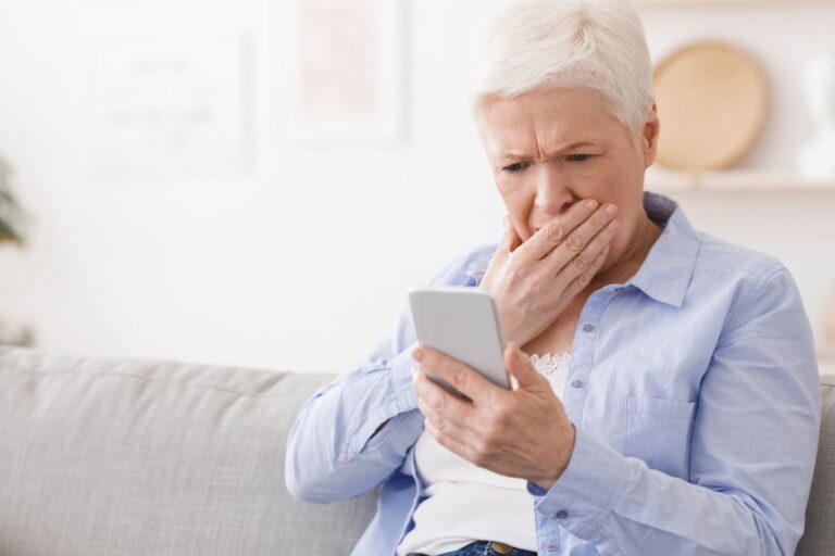 Woman looking worried looking at her phone