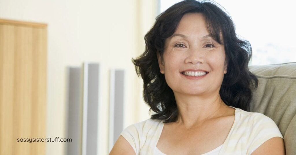 middle-age Asian woman thinking about what women over 50 say they'd never do again.