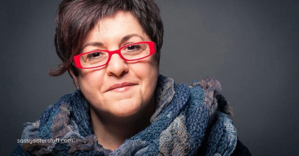 middle age woman wearing bold red glasses.