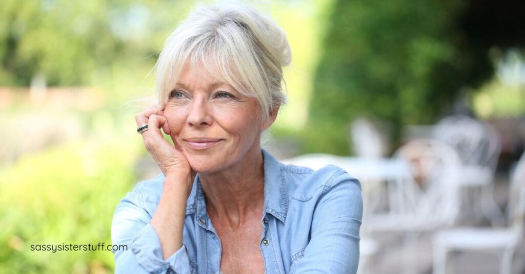 middle aged woman sitting outside on a patio contemplating life.