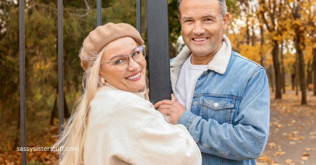 a midlife woman and man posing for a picture on their hike in the woods.