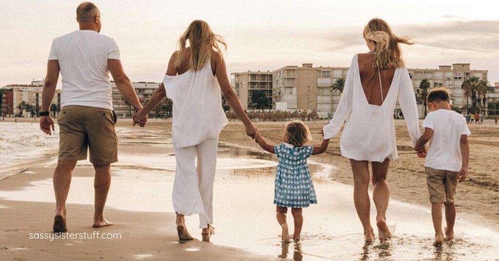 three generation family walking on the beach holding hands on the vacation they planned to connect with your adult children across the miles.