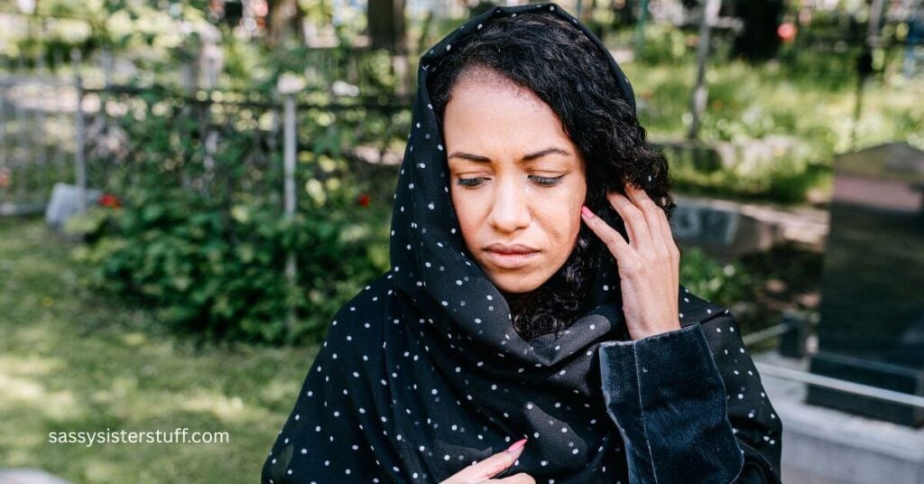 a sad women standing in a cemetery wondering why grief has no timeline.