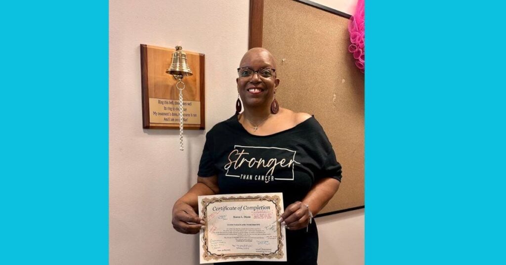 a woman rings the bell after her journey through endometrial cancer.