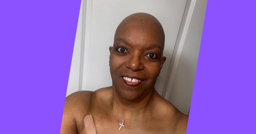 a woman smiles brightly after shaving her hair during her journey through endometrial cancer.