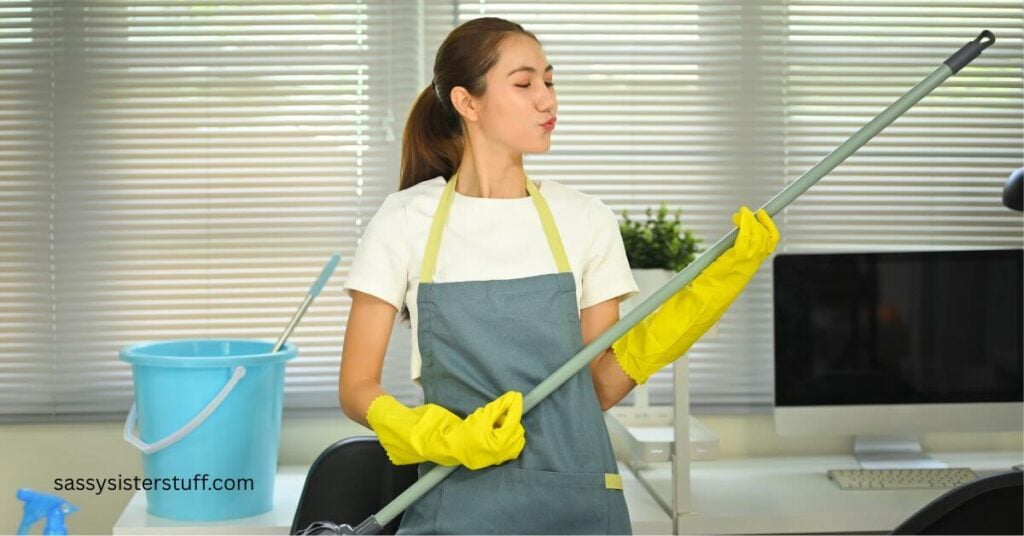 woman uses a handle extension to show a way to adapt your house cleaning habits.