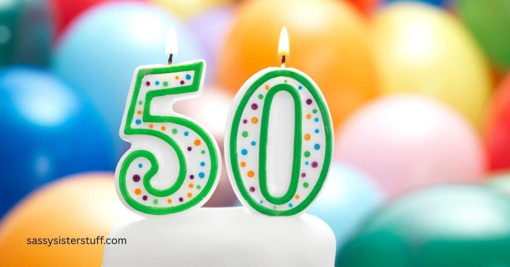 close up of candles that say 50 with balloons behind them.