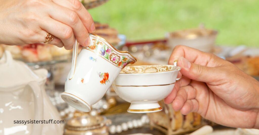 close up of two someone pouring tea into a tea cup that someone else is holding.