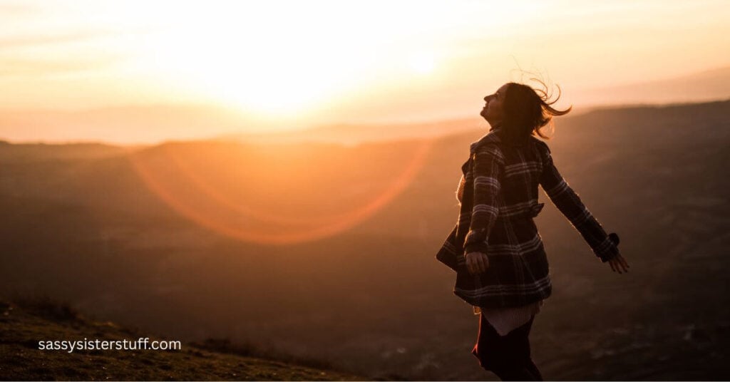 a woman in the foreground of a sunset who ponders finding yourself again in midlife.