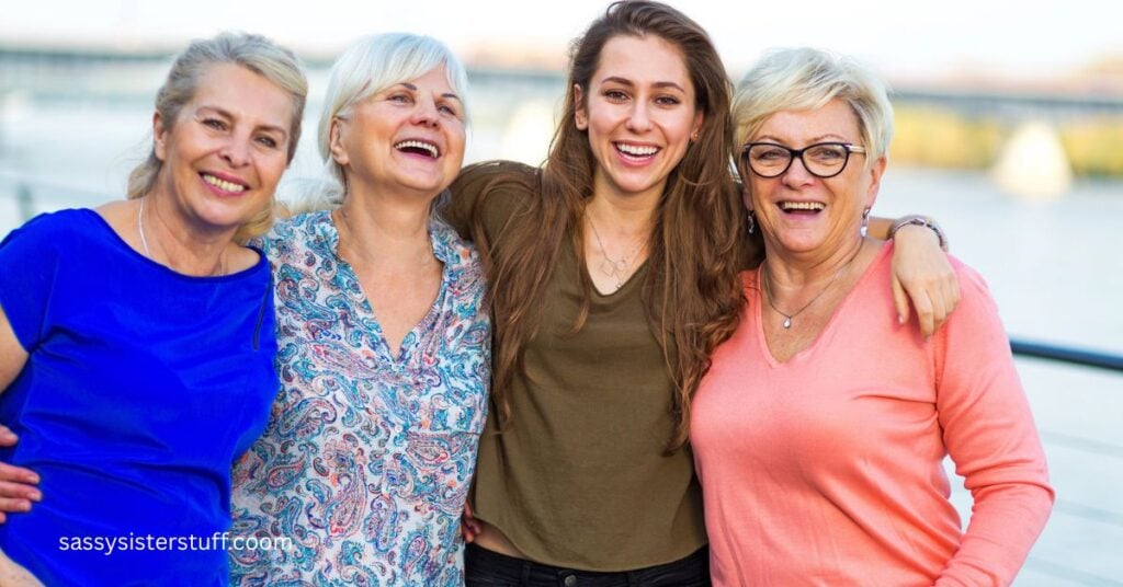Four midlife women laughing and hugging as they show friendship is a great part of life after 50.