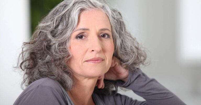 gray haired woman wonders whether life is over at 50.