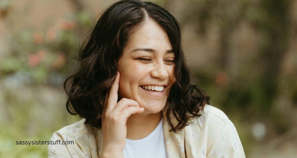 happy midlife woman spends time outside in nature for as part of her self-care habits for midlife women.