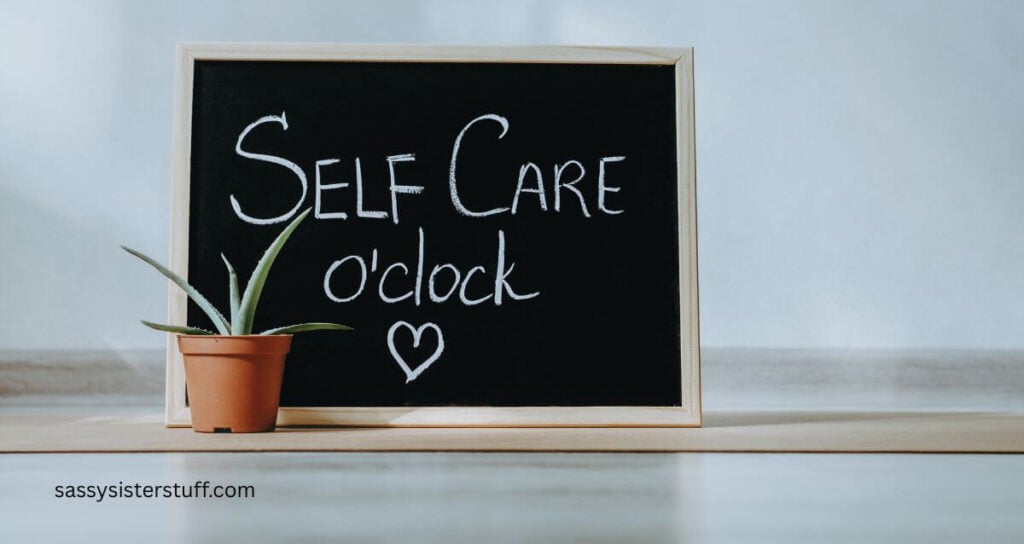 chalkboard sitting on a shelf with a small plant that reads self care o'clock.