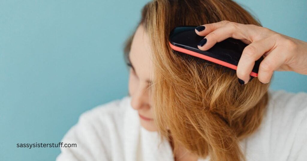 a midlife woman brushes her hair carefully after learning how menopause changes hair.