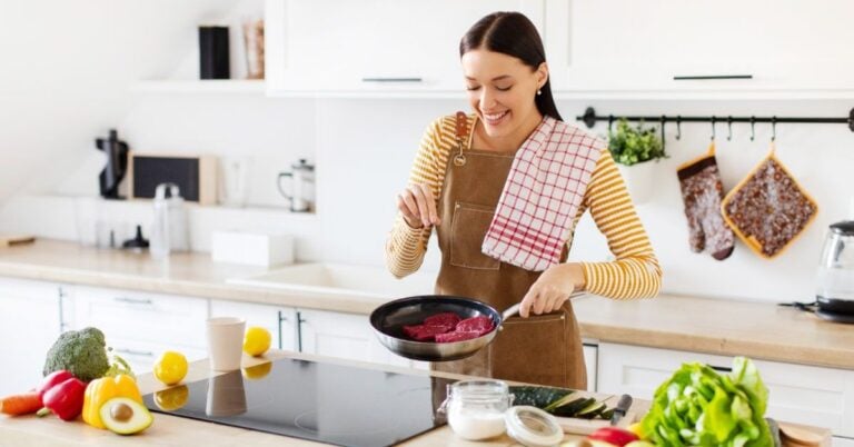 happy woman starting a new hobby, cooking in the kitchen.