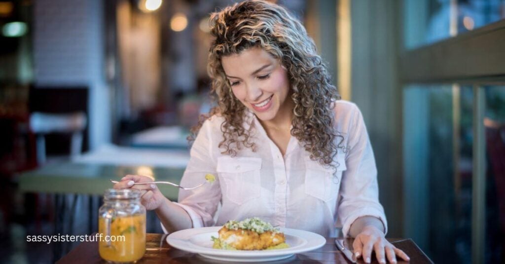middle aged woman dining alone on a healhy lunch.
